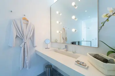 a bathroom with a sink and a large mirror at Villa Alina in Seminyak