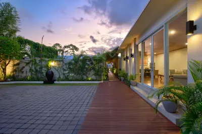 a walkway outside of a building with a sunset at The Daha Luxury Villas in Seminyak