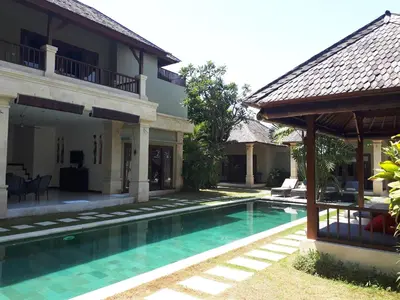 a villa with a swimming pool and a house at Villa Zanissa in Seminyak