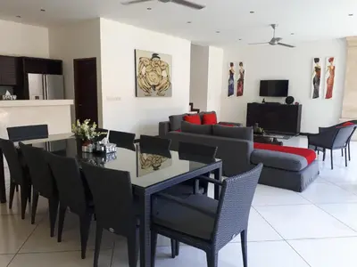 a living room with a table and chairs and a couch at Villa Zanissa in Seminyak