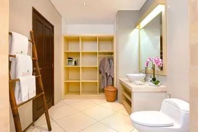 a bathroom with a toilet and a sink and a mirror at Villa Zanissa in Seminyak