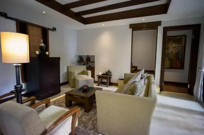 a living room with couches and chairs and a table at D'Sriwing Villa Gallery in Kuta