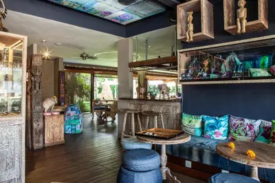 a room with a bar with blue walls at Blue Karma Dijiwa Seminyak in Seminyak