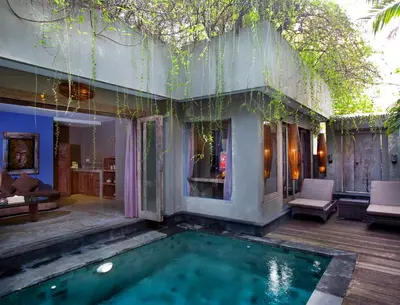 a house with a swimming pool in the yard at Blue Karma Dijiwa Seminyak in Seminyak