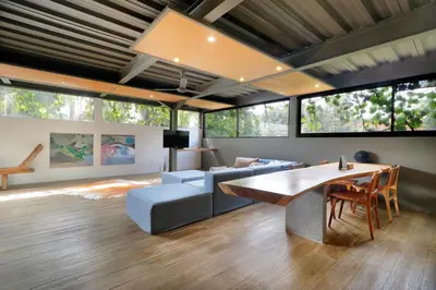 a living room with a table and a couch at Clio Apartment in Seminyak