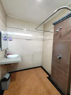 a small bathroom with a sink and a shower at La Walon Hotel in Kuta