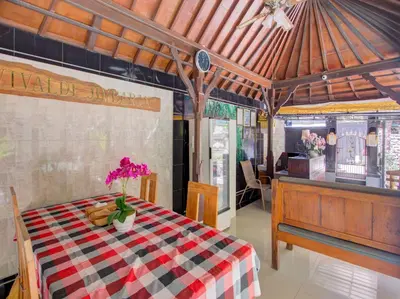 a dining room with a table with a checkered table cloth at Vivaldi Jimbaran in Jimbaran