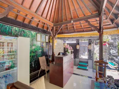 a living room with a wooden ceiling and a desk at Vivaldi Jimbaran in Jimbaran