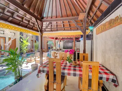 a kitchen and dining room with a table and chairs at Vivaldi Jimbaran in Jimbaran