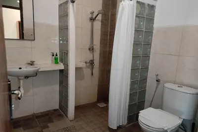 a bathroom with a shower and a toilet and a sink at Villa Puri Royan Jimbaran in Jimbaran