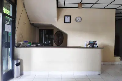 a counter in a building with a clock on the wall at Villa Puri Royan Jimbaran in Jimbaran