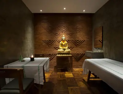 a room with a buddha statue in the middle at Maca Villas and Residence Umalas in Seminyak