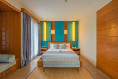 a bedroom with a king sized bed and colorful walls at Maca Villas and Residence Umalas in Seminyak