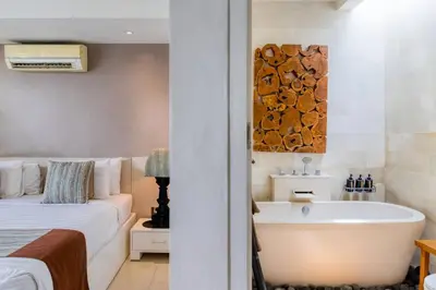 a bathroom with a bed and a tub and a bed and a bed at Private 2 Bed Pool Villa in Bustling Petitenget in Seminyak