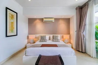 a bedroom with a large white bed and a window at Private 2 Bed Pool Villa in Bustling Petitenget in Seminyak
