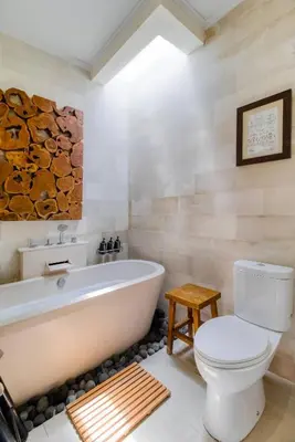 a bathroom with a white tub and a toilet at Private 2 Bed Pool Villa in Bustling Petitenget in Seminyak