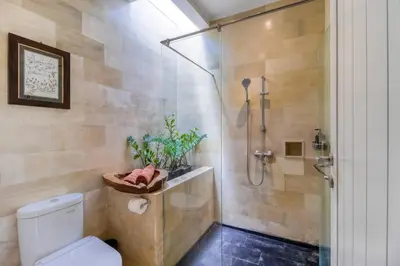 a bathroom with a shower stall and a toilet at Private 2 Bed Pool Villa in Bustling Petitenget in Seminyak