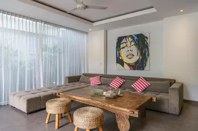 a living room with a couch and a table at Villa Paloma - Chic Tropical Garden Villa with Outdoor Pool in Seminyak