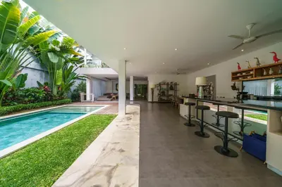 an open kitchen and swimming pool in a villa at Villa Paloma - Chic Tropical Garden Villa with Outdoor Pool in Seminyak