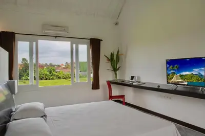 a bedroom with a bed and a window at Villa JULIA | heart of Seminyak | 350m Beach in Seminyak