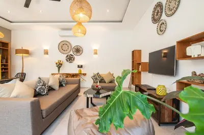 a living room with a couch and a tv at Villa Alissa in Seminyak