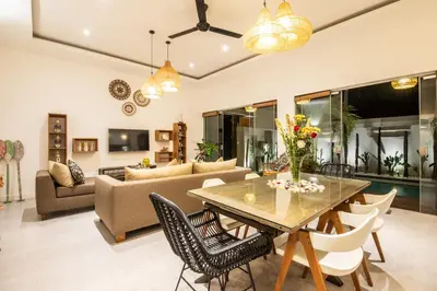 a living room with a table and chairs at Villa Alissa in Seminyak