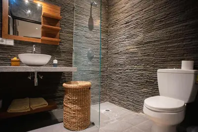 a bathroom with a toilet and a sink at Villa Zaïna in Seminyak