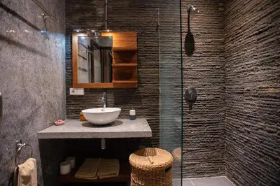 a bathroom with a sink and a glass shower at Villa Zaïna in Seminyak