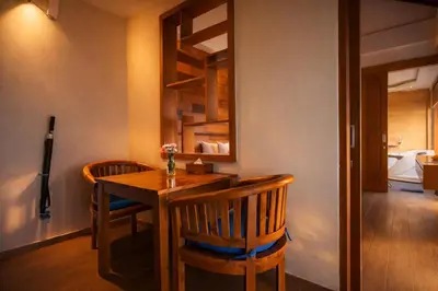 a dining room with a table and two chairs at The Wina Villa Seminyak by The Wina Resorts in Seminyak