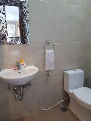 a bathroom with a sink and a toilet and a mirror at Villa Kora in Seminyak