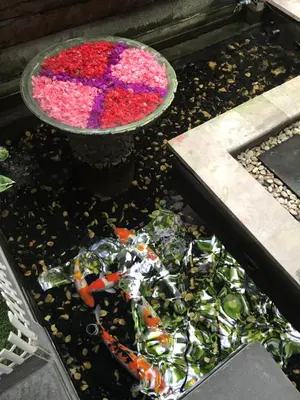 a bowl filled with flowers and a pile of trash at The Nakula Villas in Legian