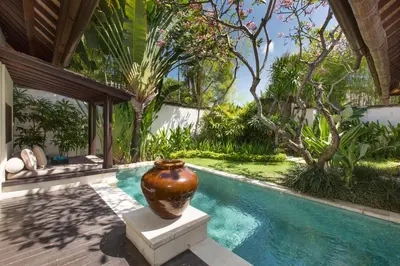 a large vase sitting next to a swimming pool at Villa Air Bali Boutique Resort and Spa in Seminyak