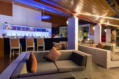 a living room with a couch and a bar at Kuta Beach Hotel in Kuta