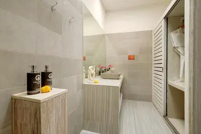 a bathroom with a sink and a mirror at Bali Cosy Villas Seminyak in Legian