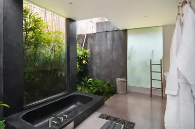 a bathroom with a black sink and a window at Villa Alice by Villa Finder in Seminyak
