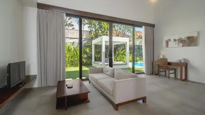 a living room with a couch and a table at Villa Alice by Villa Finder in Seminyak