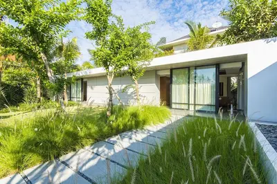 a house with a garden in front of it at Villa Keila Seminyak in Seminyak