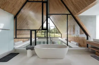 a bathroom with a large tub in a room with windows at Villa Keila Seminyak in Seminyak