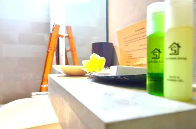 a counter with a bottle and a plate of food on it at Jas Boutique Villas in Seminyak