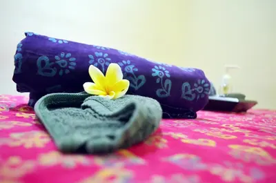 a yellow flower sitting on top of a table at Jas Boutique Villas in Seminyak