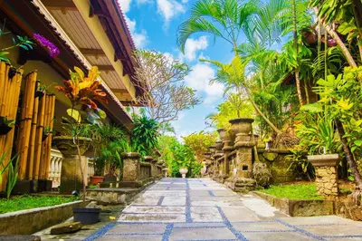 a cobblestone street in a courtyard of a building at Restu Bali Hotel in Legian