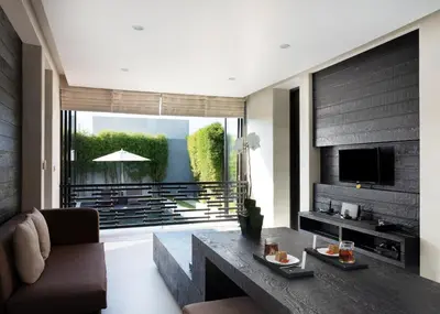 a living room with a couch and a table at eqUILIBRIA Seminyak in Seminyak