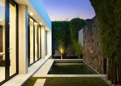 a swimming pool in the middle of a house at eqUILIBRIA Seminyak in Seminyak