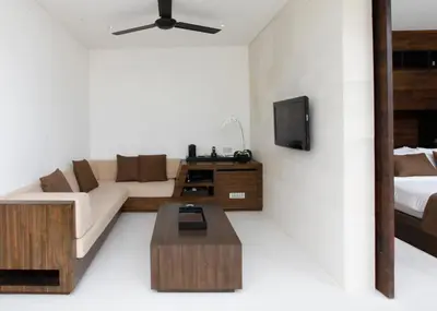 a living room with a couch and a tv at eqUILIBRIA Seminyak in Seminyak