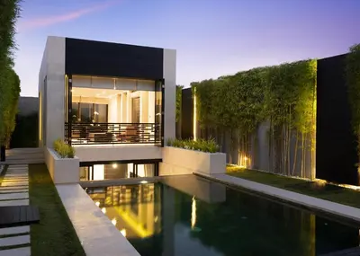 a house with a swimming pool in front of it at eqUILIBRIA Seminyak in Seminyak