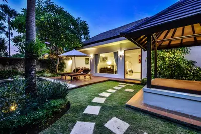 a garden with a patio and a house at The Yubi Boutique Villas Seminyak in Seminyak