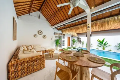 an open living room with a wooden ceiling at Villa Jimmy in Seminyak