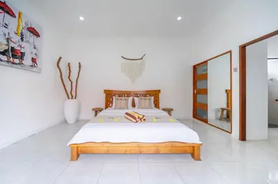 a bedroom with a bed and a vase at Villa Jimmy in Seminyak