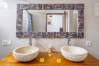 two sinks in a bathroom with a mirror at Villa Jimmy in Seminyak