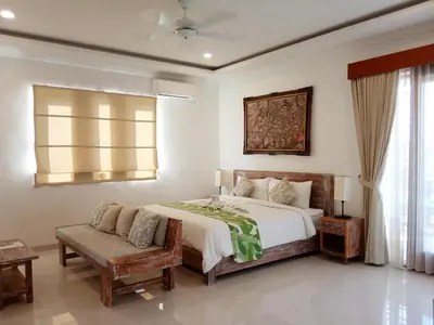 a bedroom with a bed and a couch in it at ★ VIP ★ Green Studio Apartment in Seminyak, No.23 in Seminyak
